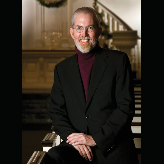 Rev. Forrest Church, posing for a formal 3/4 shot in front of a pulpit.. Photo by Mitchel Gray.